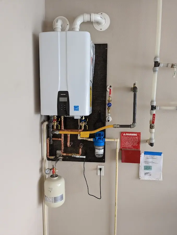 Professional plumber installing copper piping in a Rutherford home